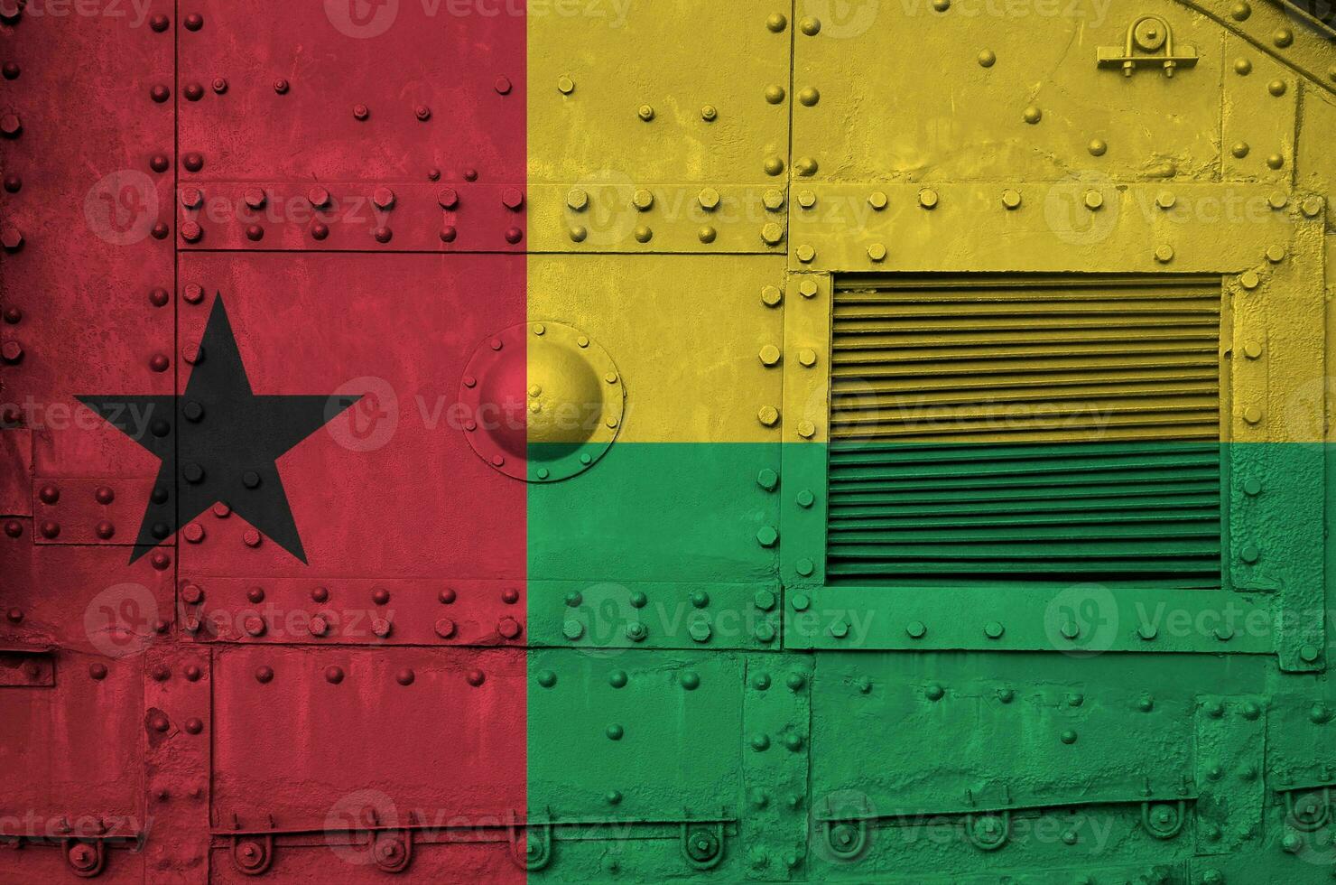 Guinea Bissau flag depicted on side part of military armored tank closeup. Army forces conceptual background photo