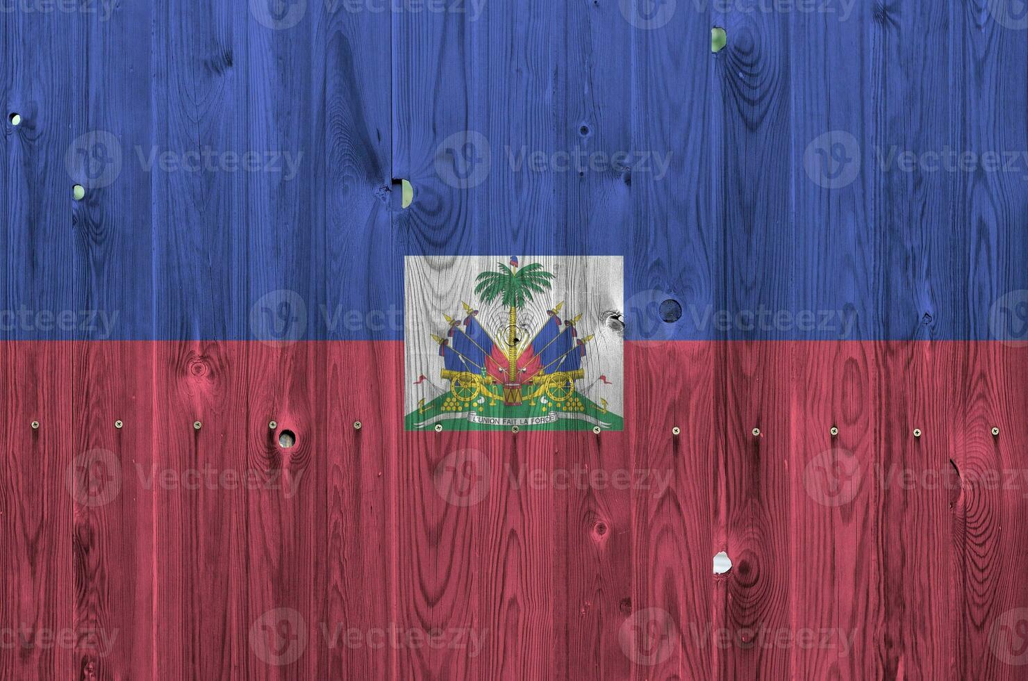 Haiti flag depicted in bright paint colors on old wooden wall. Textured banner on rough background photo