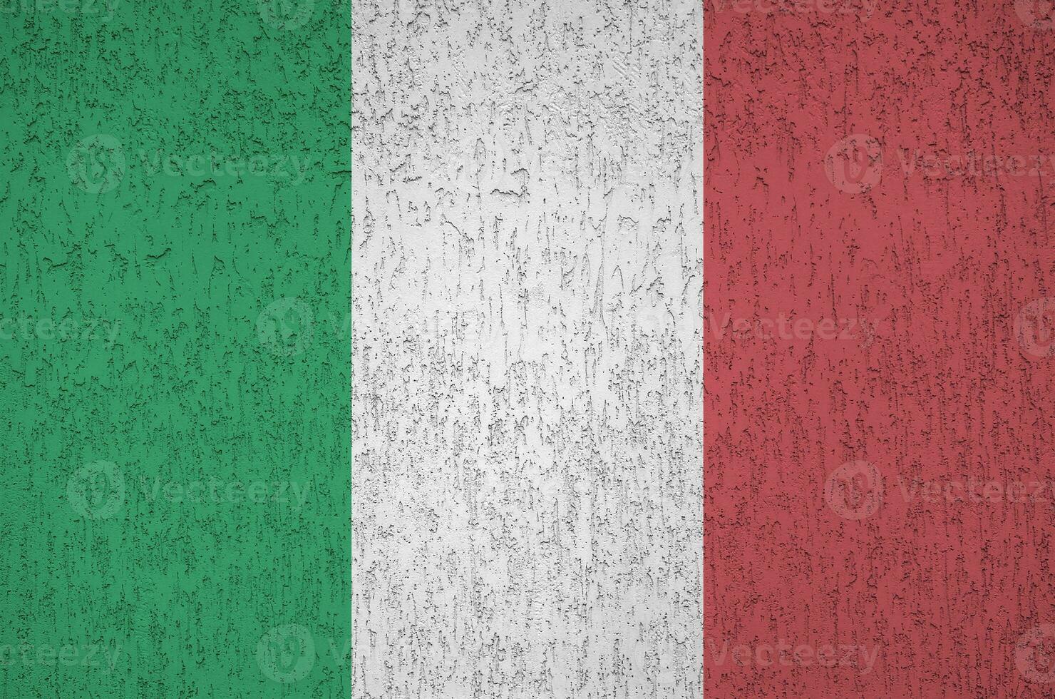 Italy flag depicted in bright paint colors on old relief plastering wall. Textured banner on rough background photo