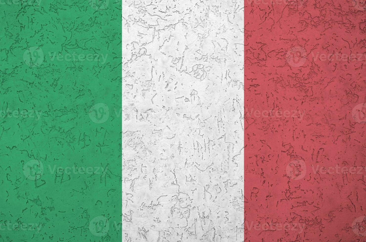 Italy flag depicted in bright paint colors on old relief plastering wall. Textured banner on rough background photo