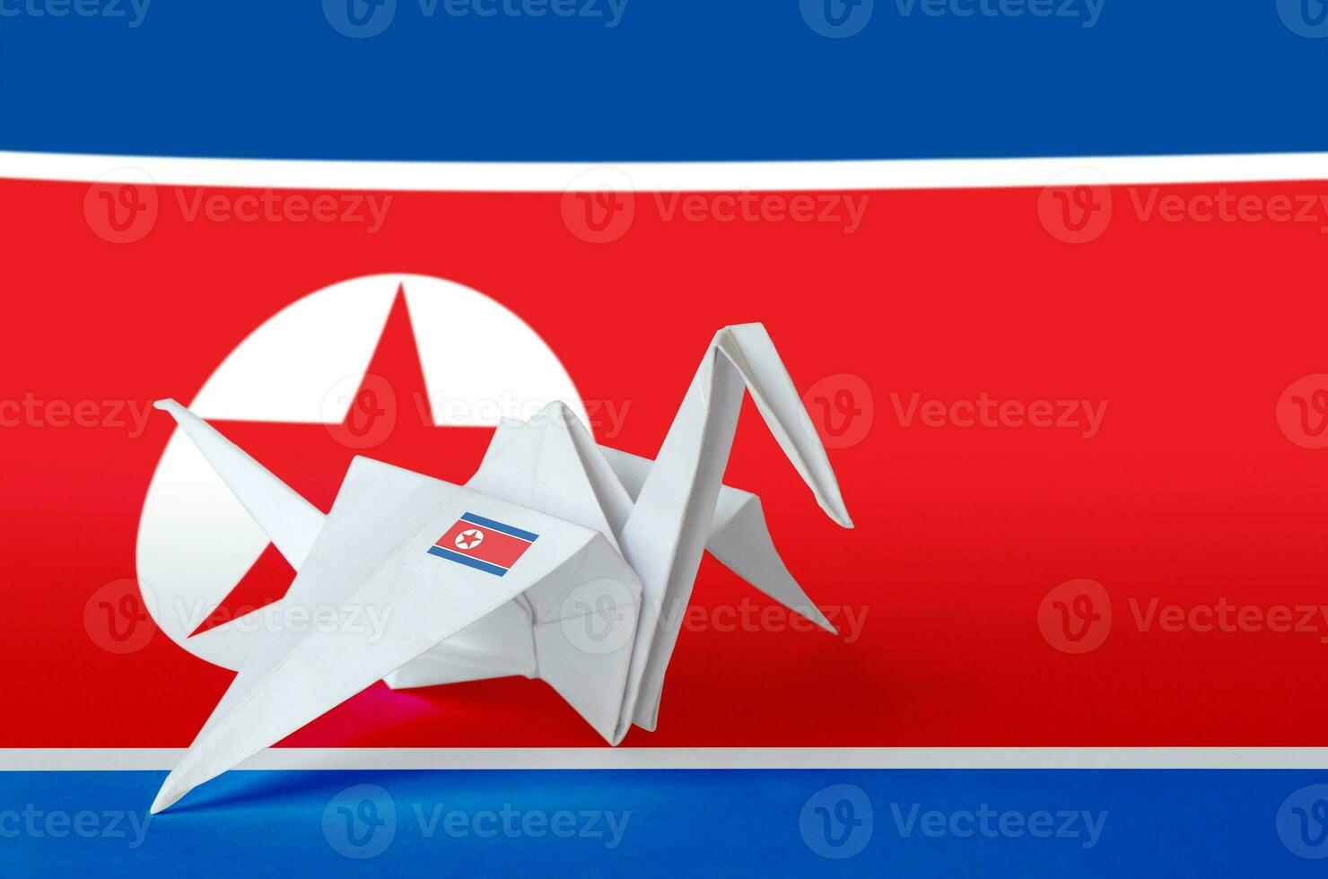 North Korea flag depicted on paper origami crane wing. Handmade arts concept photo