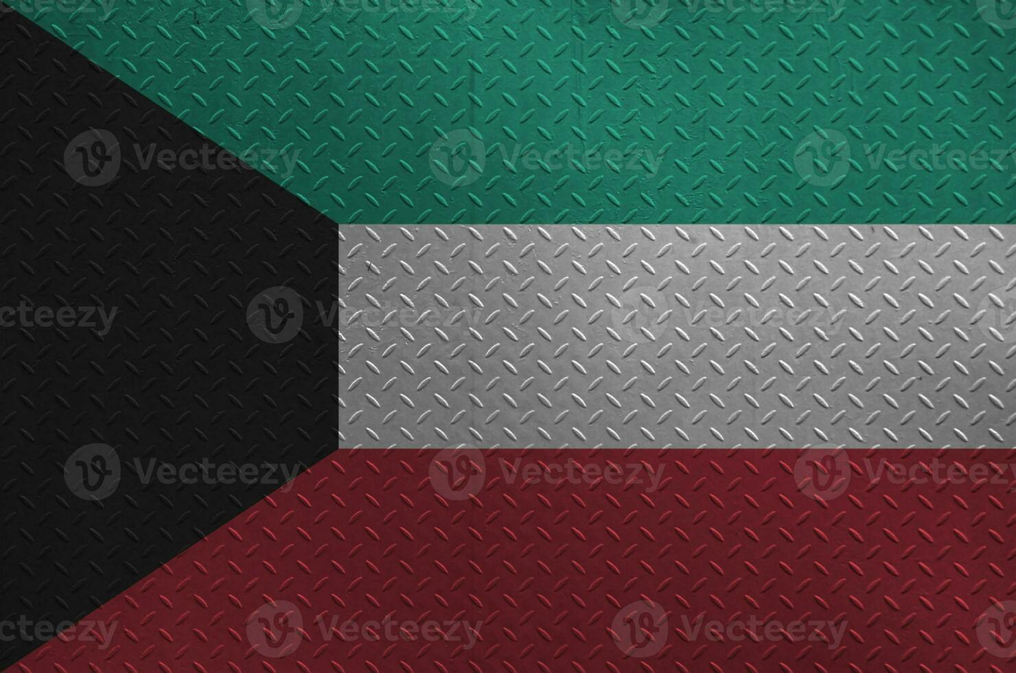 Kuwait flag depicted in paint colors on old brushed metal plate or wall closeup. Textured banner on rough background photo