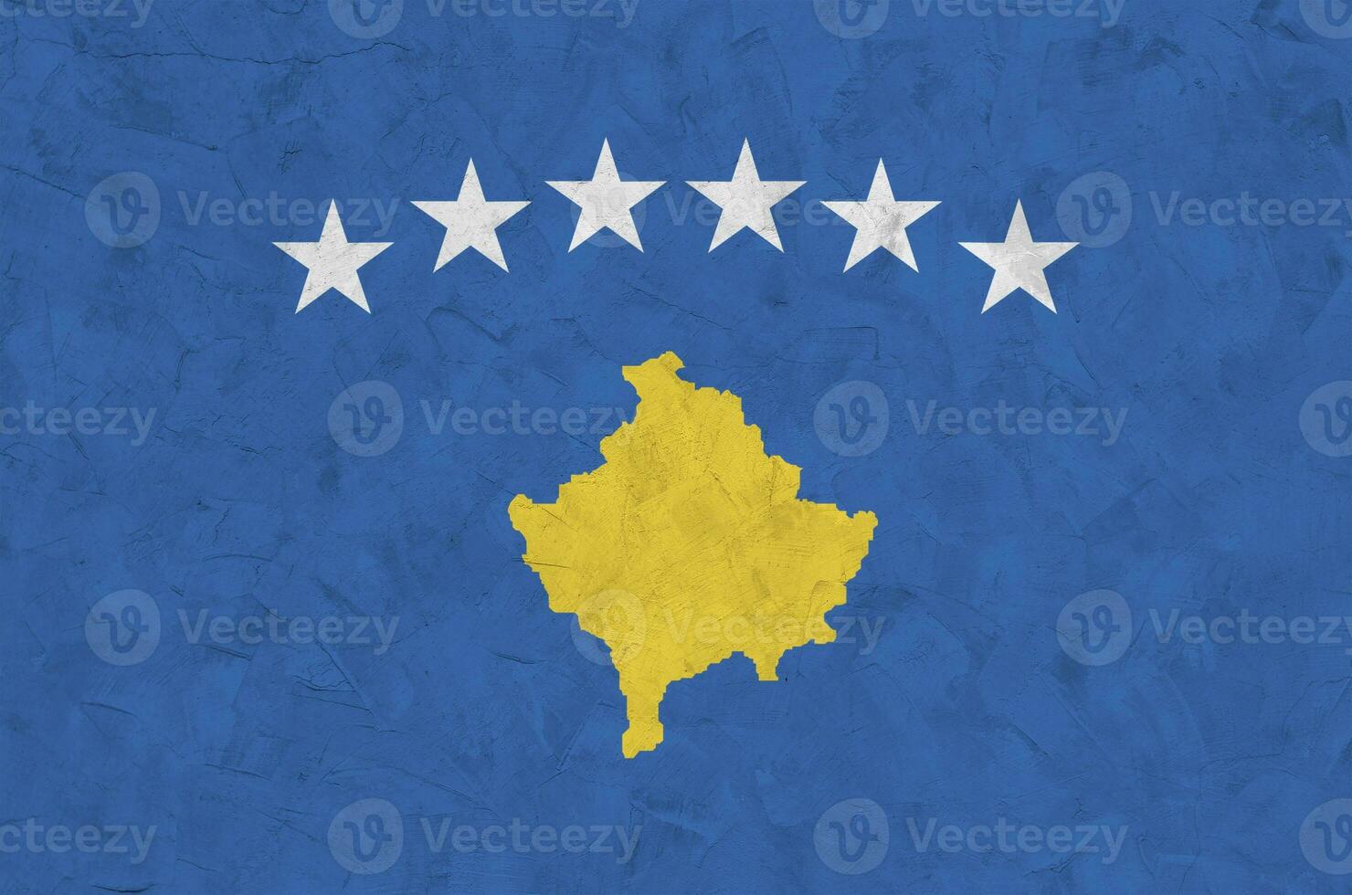 Kosovo flag depicted in bright paint colors on old relief plastering wall. Textured banner on rough background photo