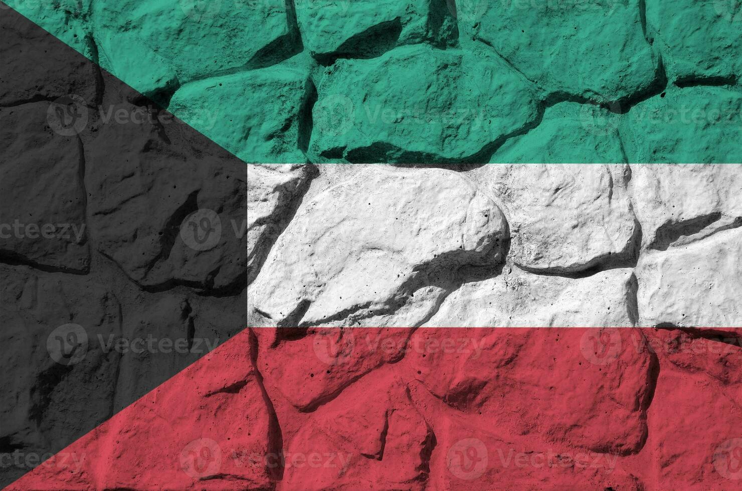 Kuwait flag depicted in paint colors on old stone wall closeup. Textured banner on rock wall background photo