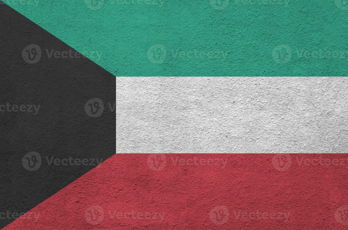 Kuwait flag depicted in bright paint colors on old relief plastering wall. Textured banner on rough background photo