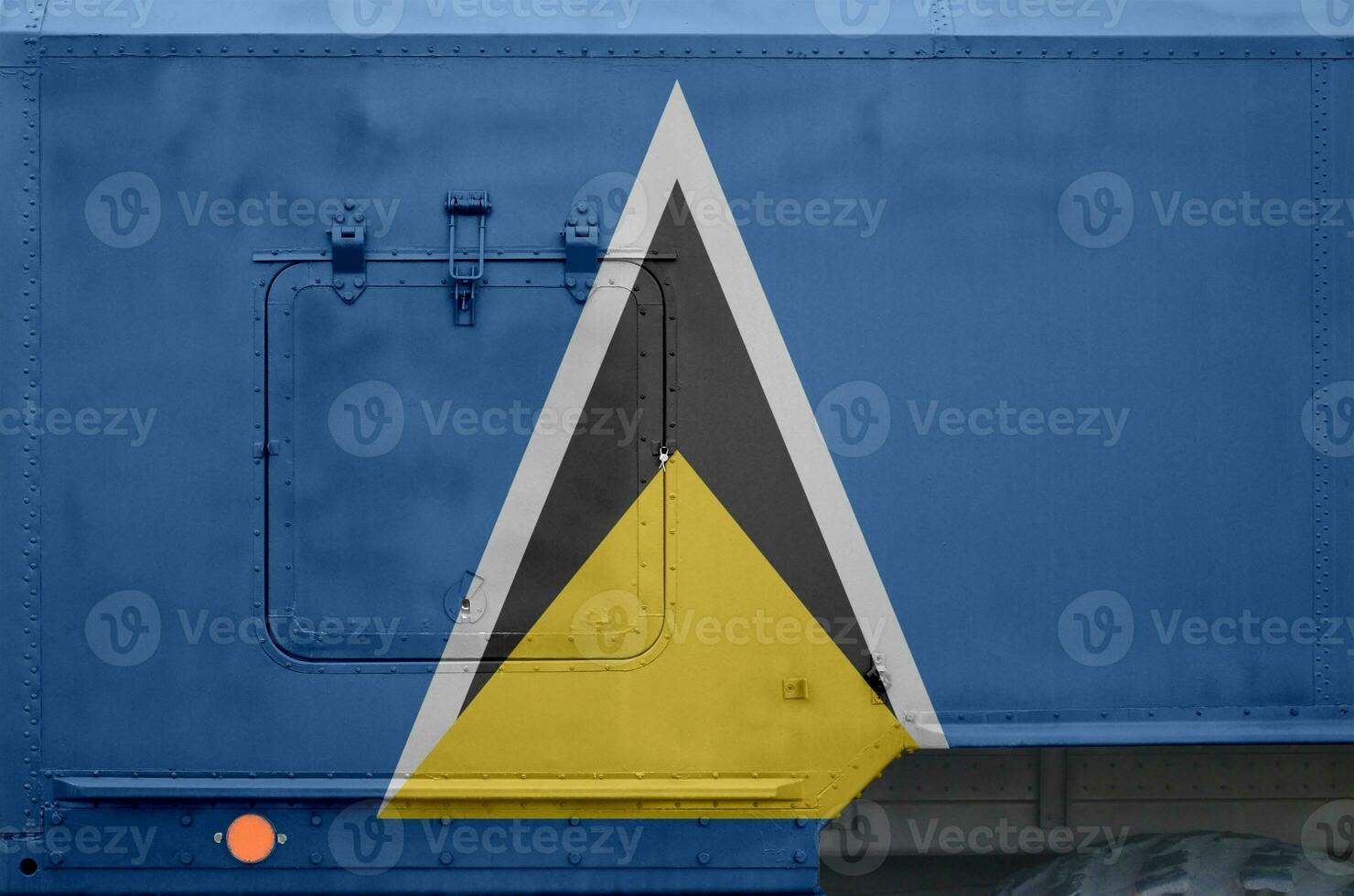 Saint Lucia flag depicted on side part of military armored truck closeup. Army forces conceptual background photo