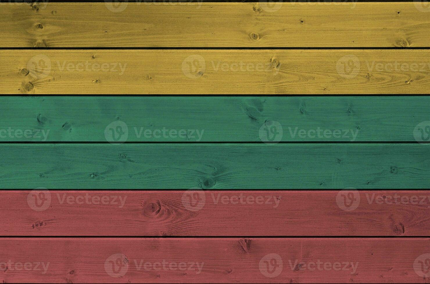 Lithuania flag depicted in bright paint colors on old wooden wall. Textured banner on rough background photo