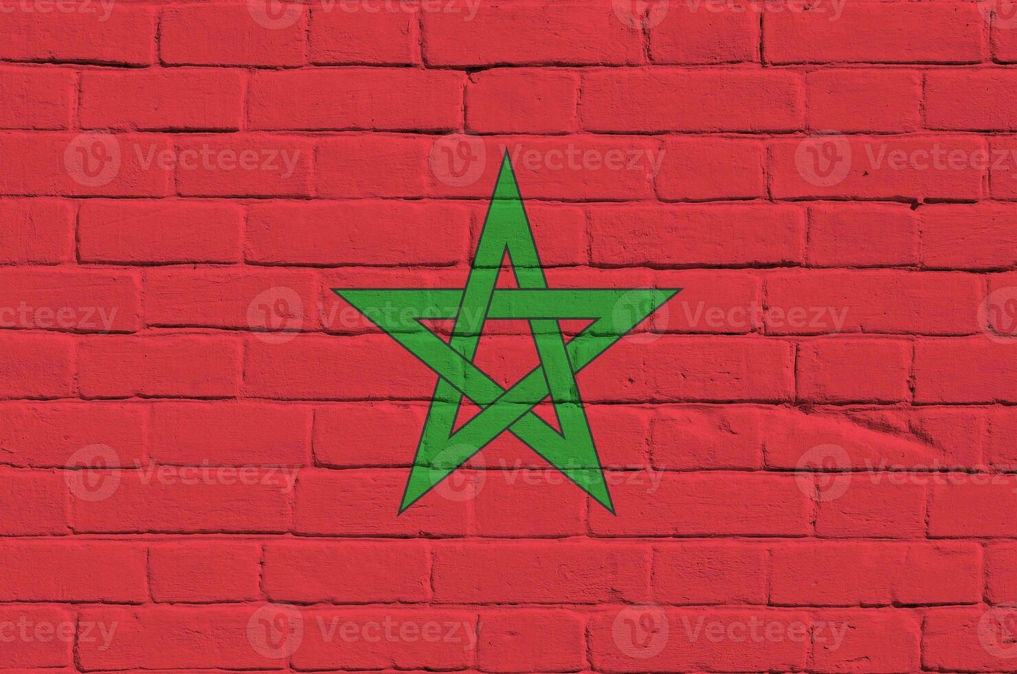 Morocco flag depicted in paint colors on old brick wall. Textured banner on big brick wall masonry background photo