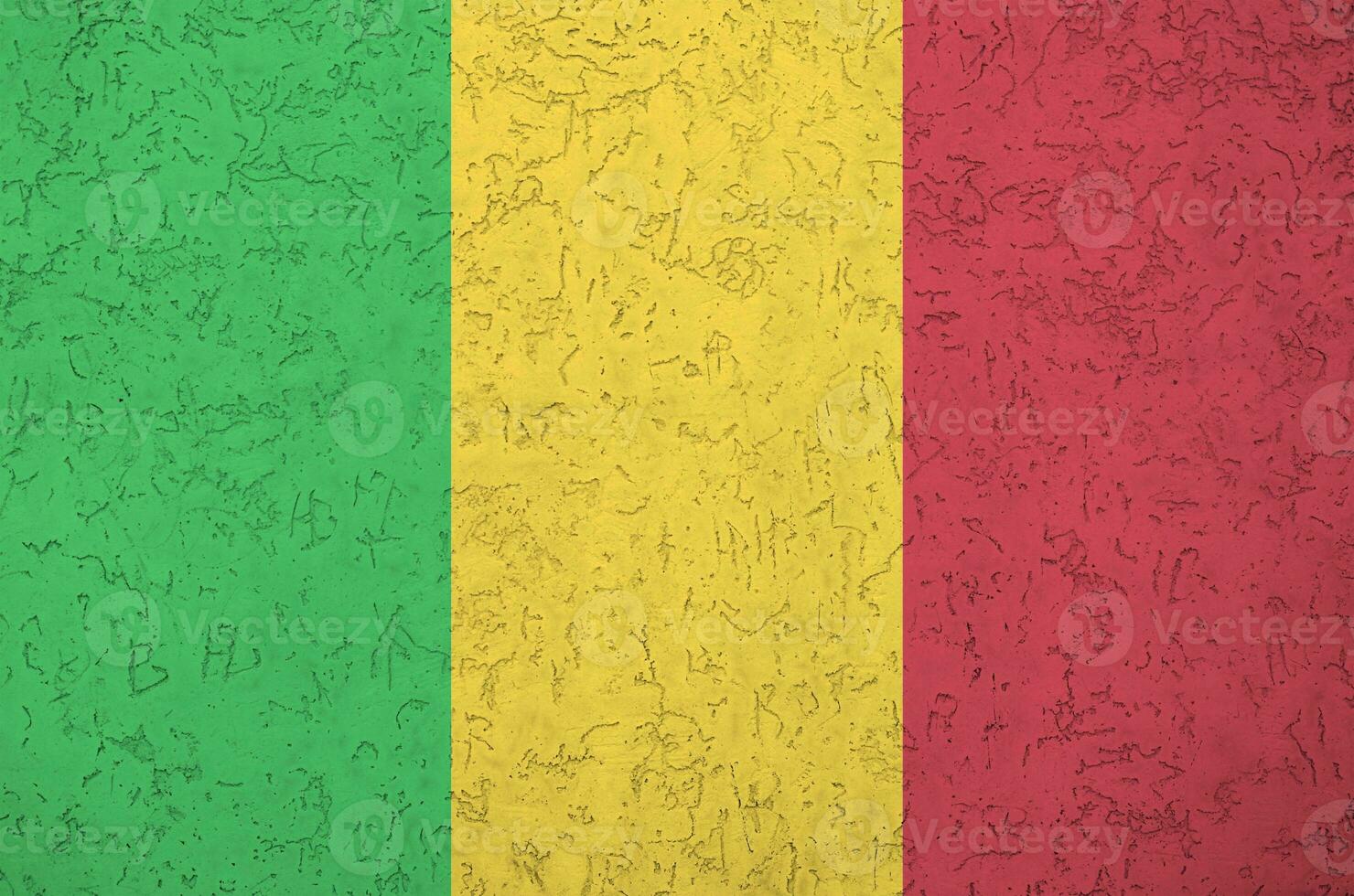 Mali flag depicted in bright paint colors on old relief plastering wall. Textured banner on rough background photo