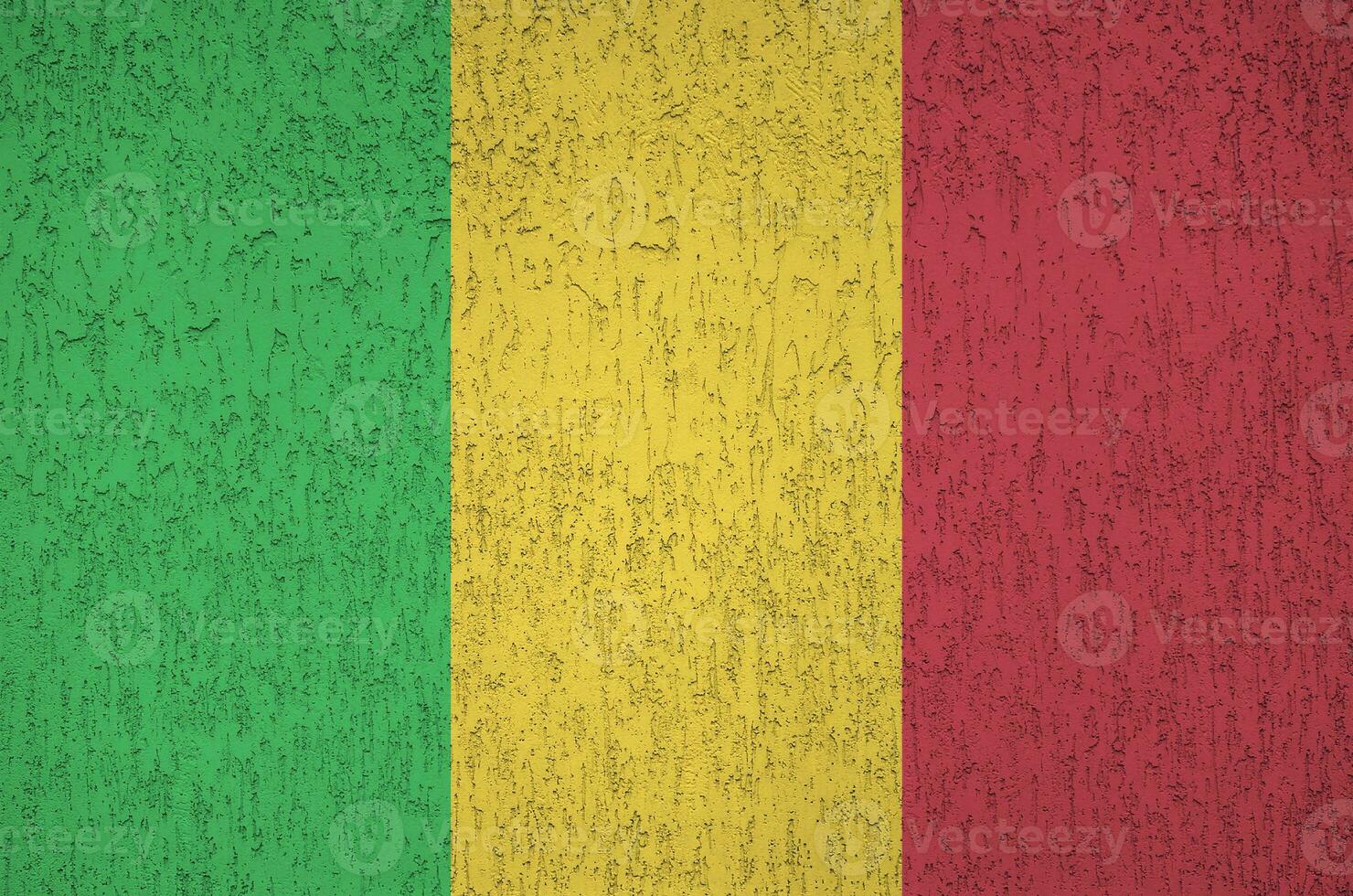 Mali flag depicted in bright paint colors on old relief plastering wall. Textured banner on rough background photo