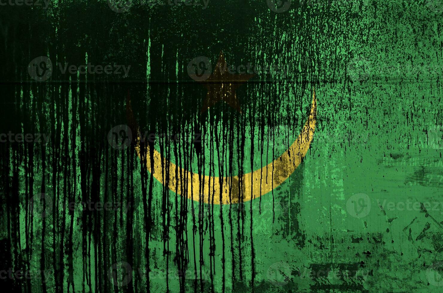 Mauritania flag depicted in paint colors on old and dirty oil barrel wall closeup. Textured banner on rough background photo