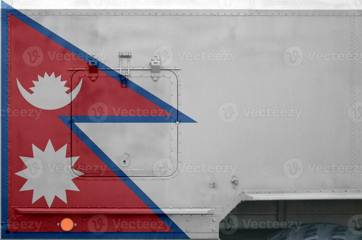 Nepal flag depicted on side part of military armored truck closeup. Army forces conceptual background photo