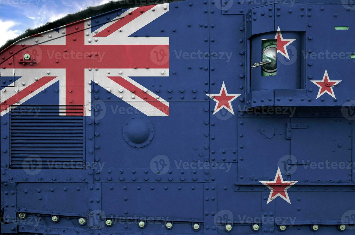 New Zealand flag depicted on side part of military armored tank closeup. Army forces conceptual background photo