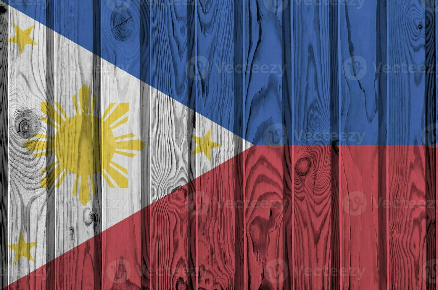 Philippines flag depicted in bright paint colors on old wooden wall. Textured banner on rough background photo