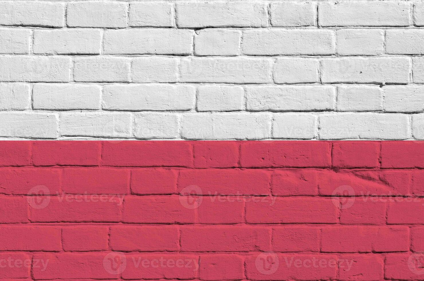 Poland flag depicted in paint colors on old brick wall. Textured banner on big brick wall masonry background photo