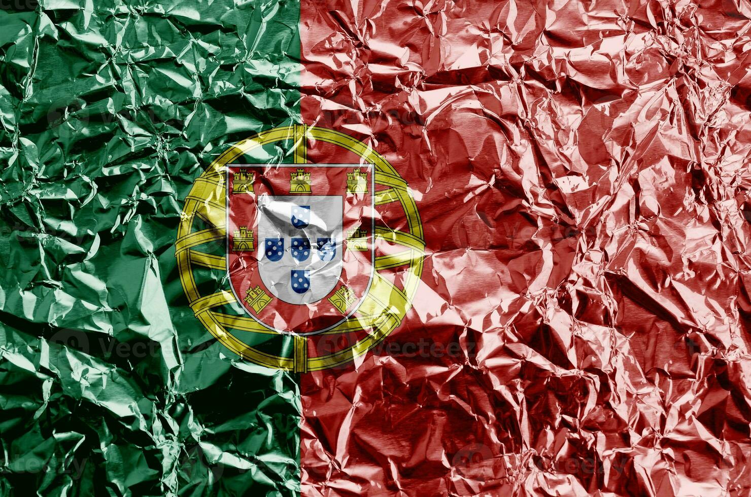 Portugal flag depicted in paint colors on shiny crumpled aluminium foil closeup. Textured banner on rough background photo