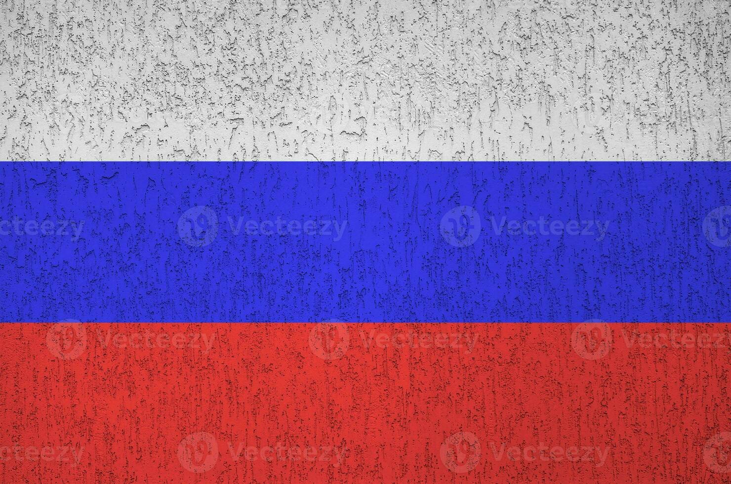 Russia flag depicted in bright paint colors on old relief plastering wall. Textured banner on rough background photo