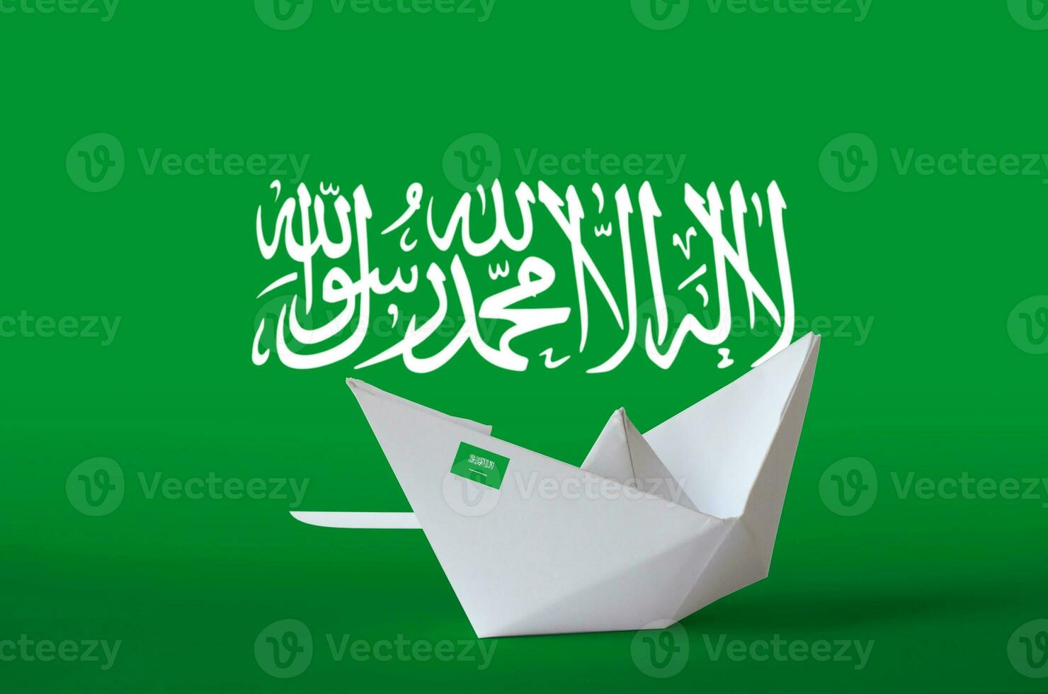 Saudi Arabia flag depicted on paper origami ship closeup. Handmade arts concept photo