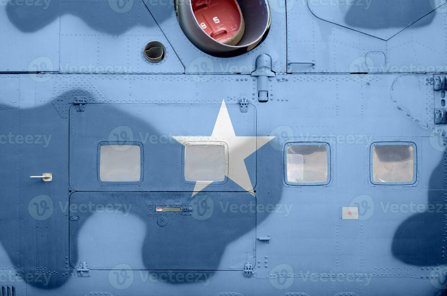 Somalia flag depicted on side part of military armored helicopter closeup. Army forces aircraft conceptual background photo