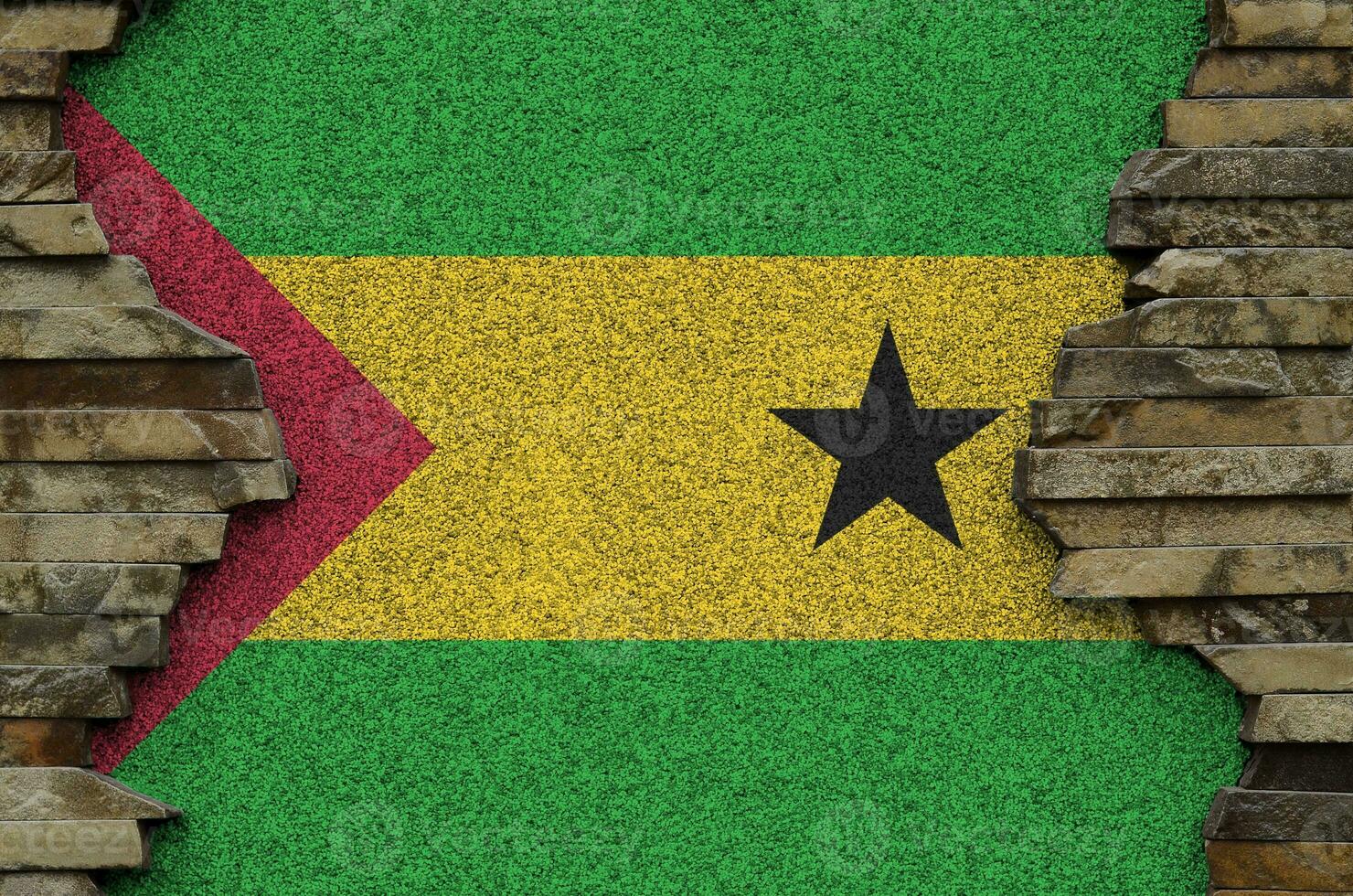 Sao Tome and Principe flag depicted in paint colors on old stone wall closeup. Textured banner on rock wall background photo