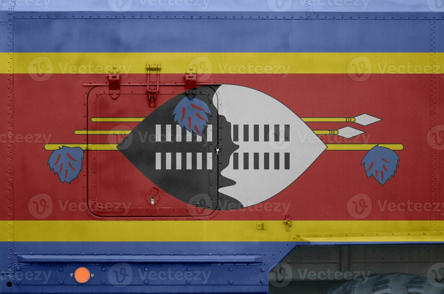 Swaziland flag depicted on side part of military armored truck closeup. Army forces conceptual background photo