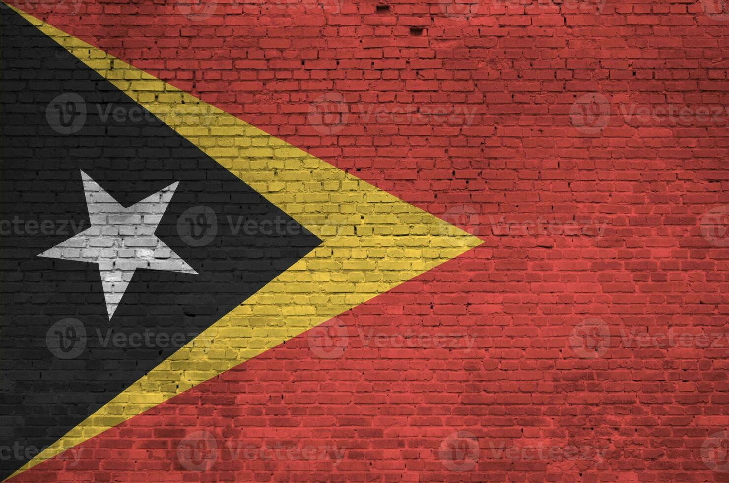 Timor Leste flag depicted in paint colors on old brick wall. Textured