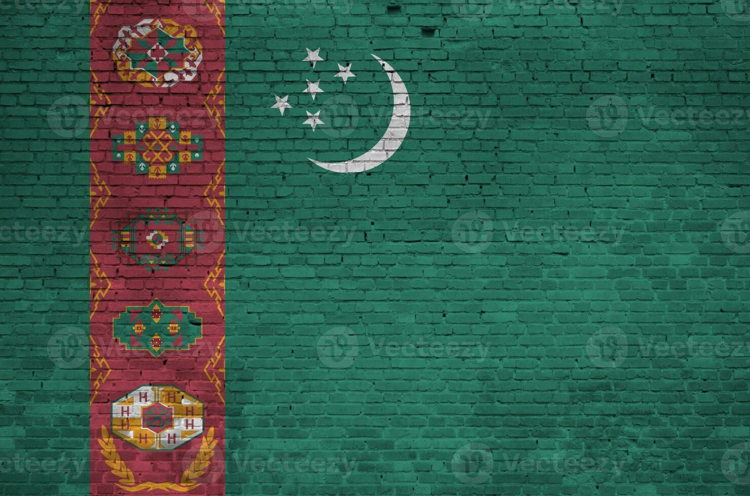 Turkmenistan flag depicted in paint colors on old brick wall. Textured banner on big brick wall masonry background photo