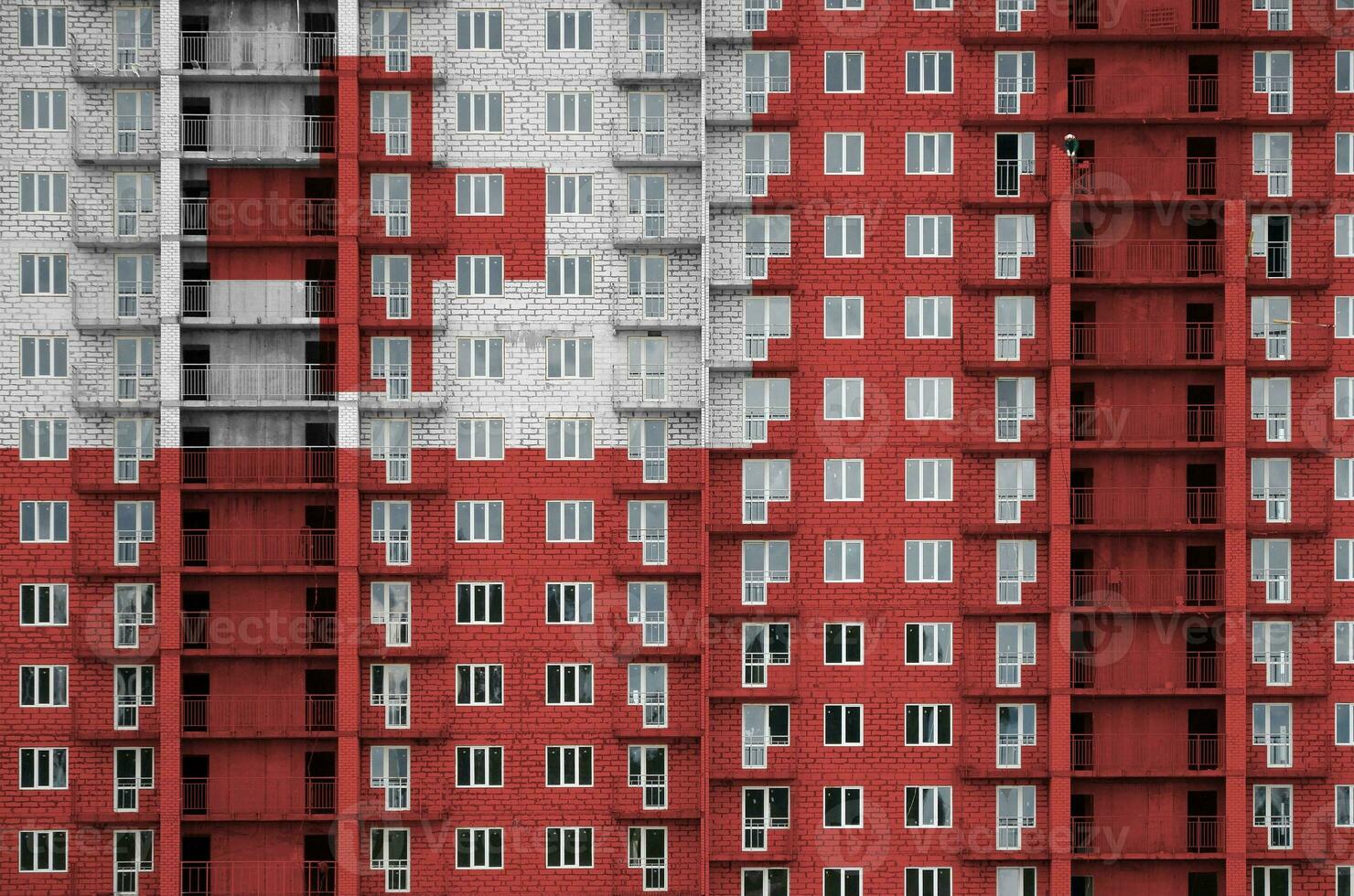 Tonga flag depicted in paint colors on multi-storey residental building under construction. Textured banner on brick wall background photo