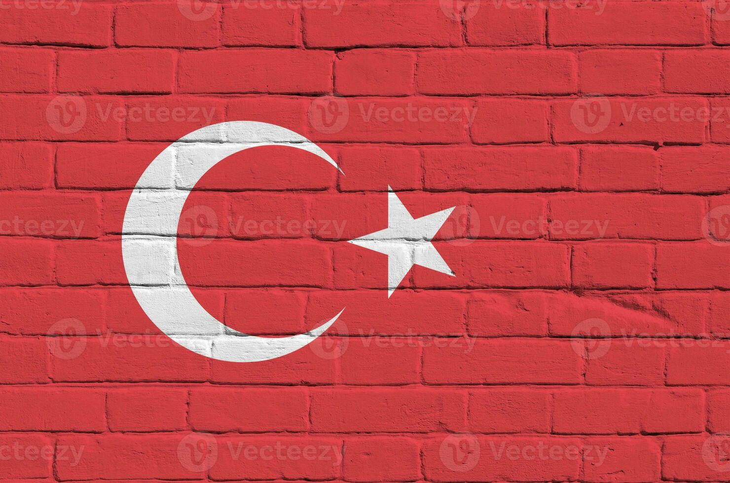 Turkey flag depicted in paint colors on old brick wall. Textured banner on big brick wall masonry background photo