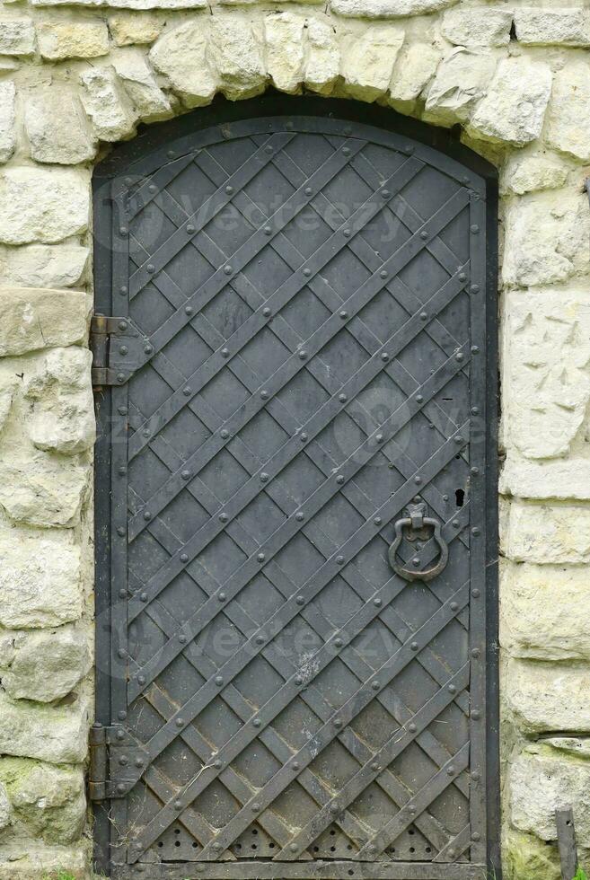 Old ancient metal door texture in european medieval style photo