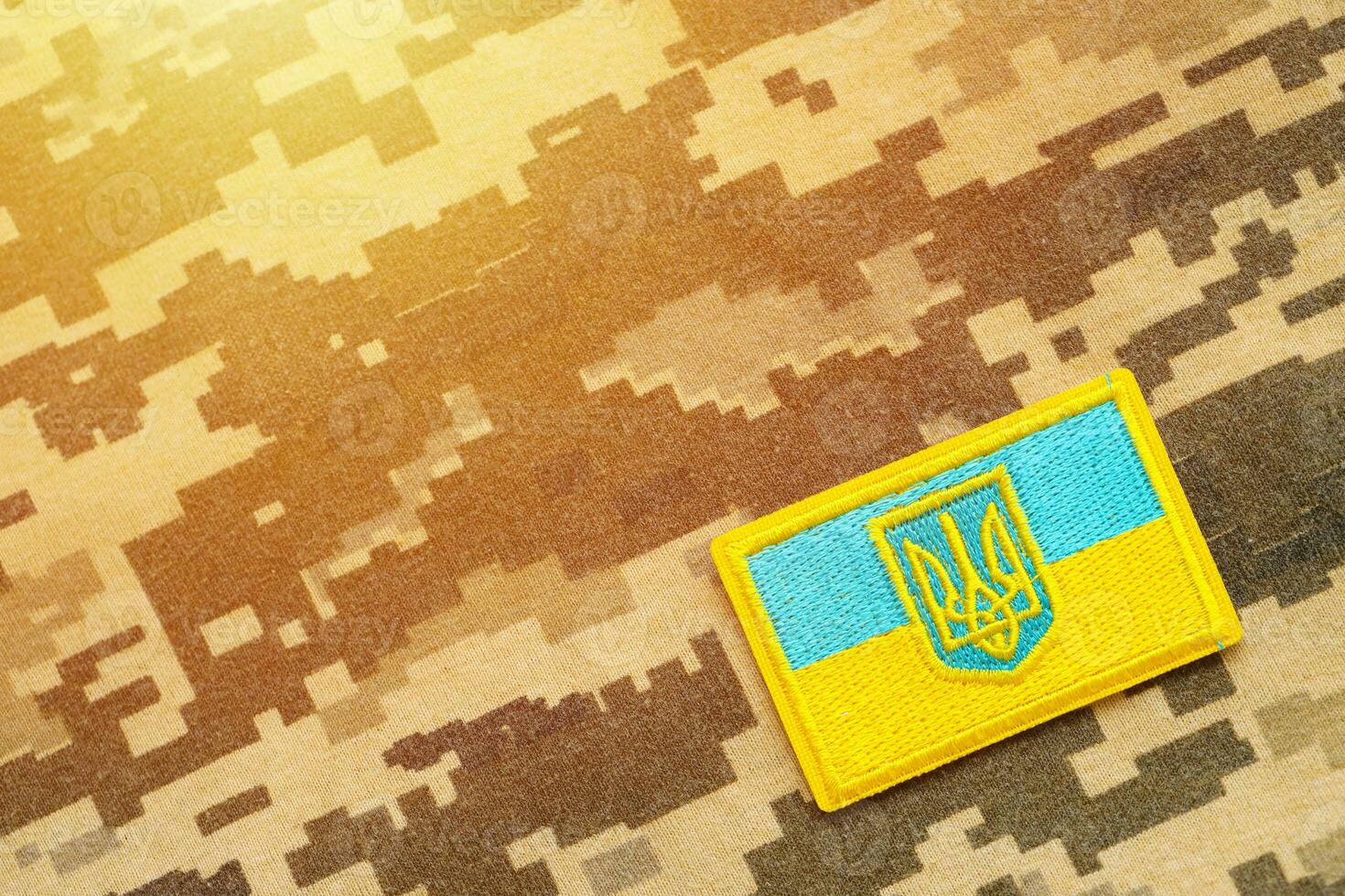 Military camouflage fabric with ukrainian flag on uniform chevron photo