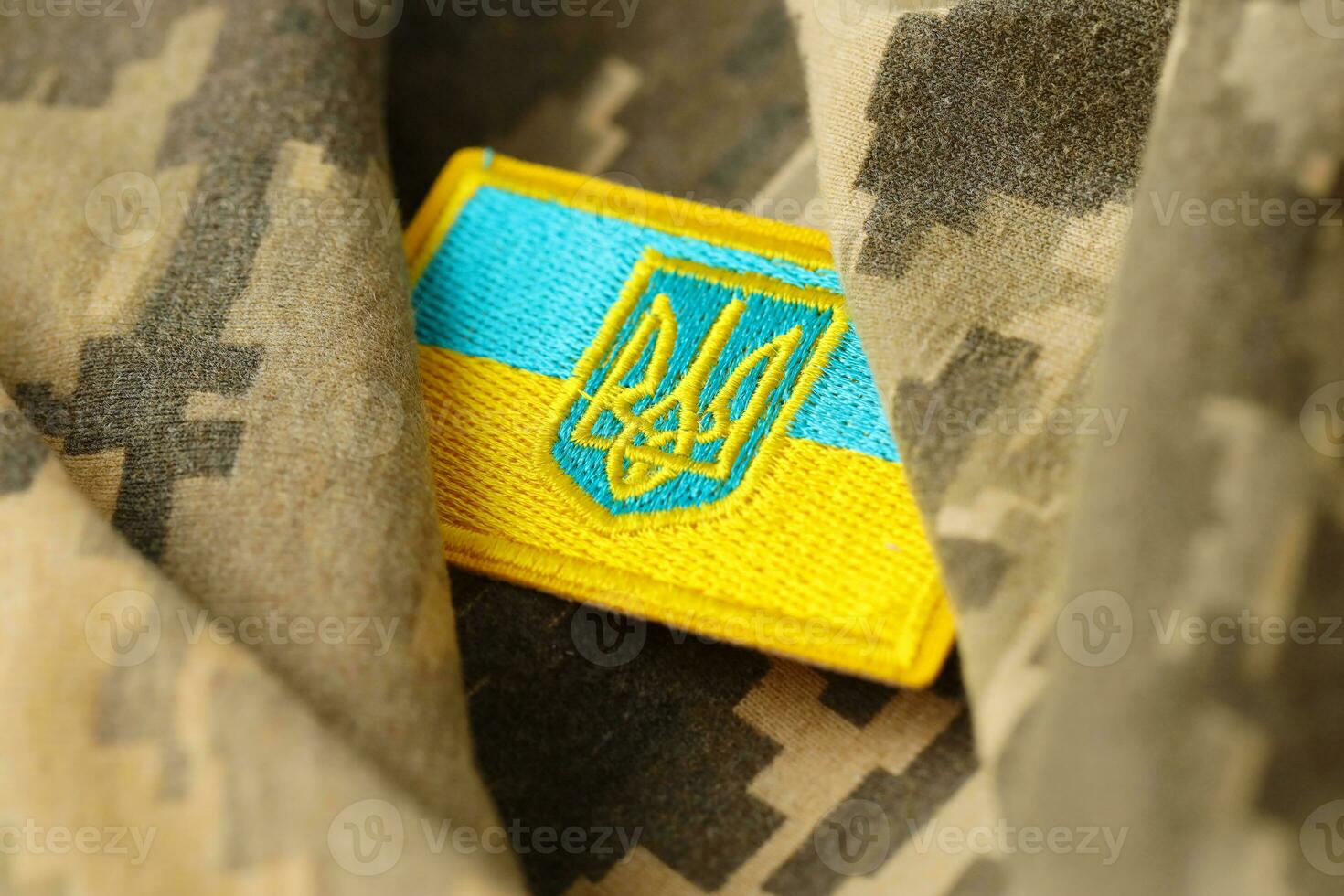 Military camouflage fabric with ukrainian flag on uniform chevron photo