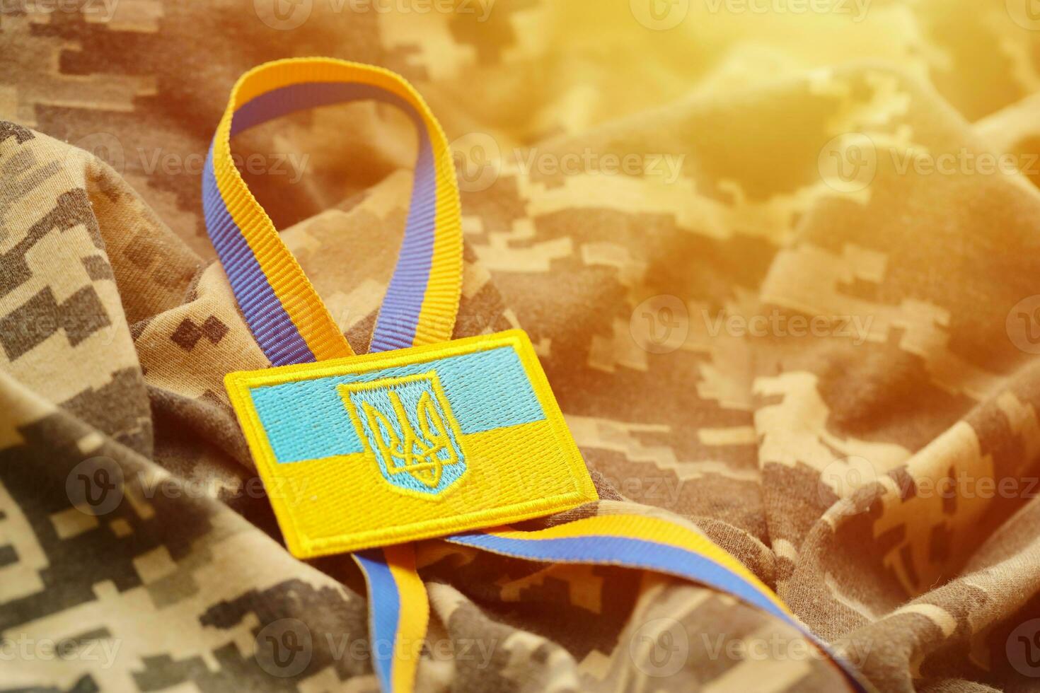 Military camouflage fabric with ukrainian flag on uniform chevron photo