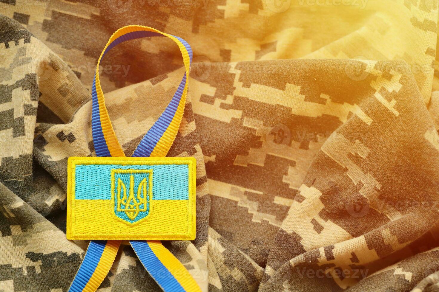 Military camouflage fabric with ukrainian flag on uniform chevron photo