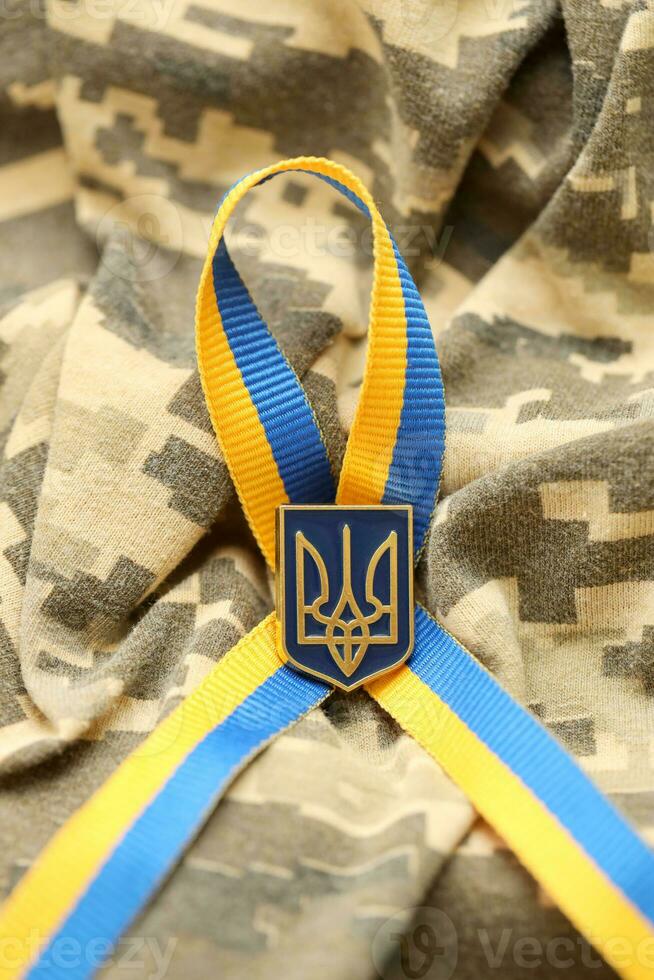 Military camouflage fabric with ukrainian stripes on ribbon photo