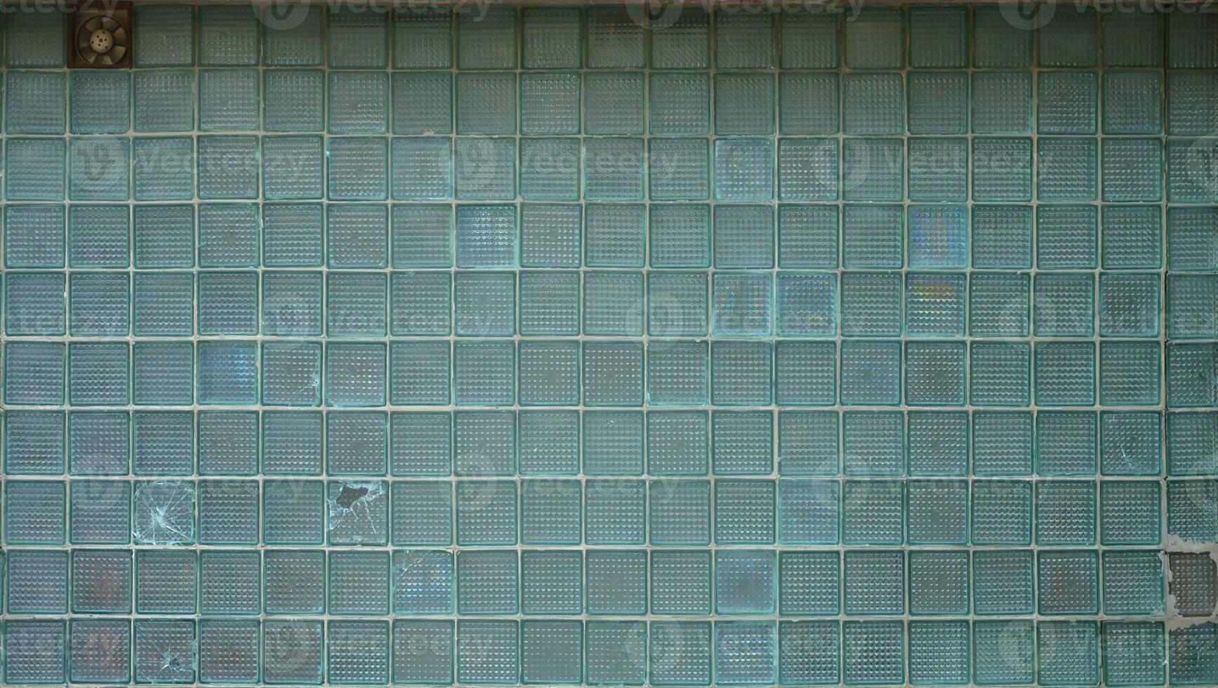 Glass blocks wall texture with small factory vent photo