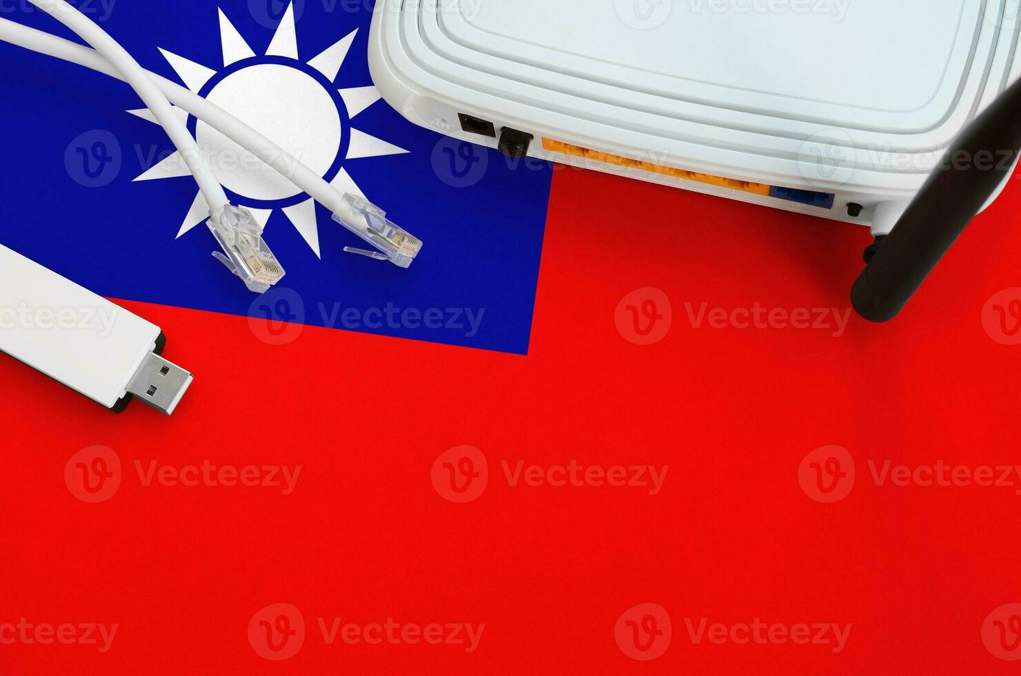 Taiwan flag depicted on table with internet rj45 cable, wireless usb wifi adapter and router. Internet connection concept photo