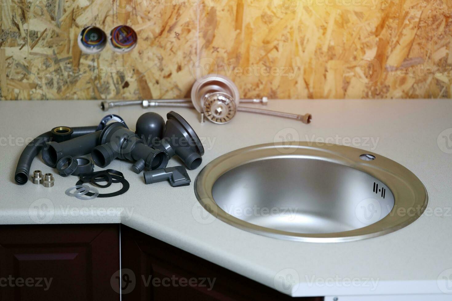 Tools and water tap ready for installation sink on countertop photo