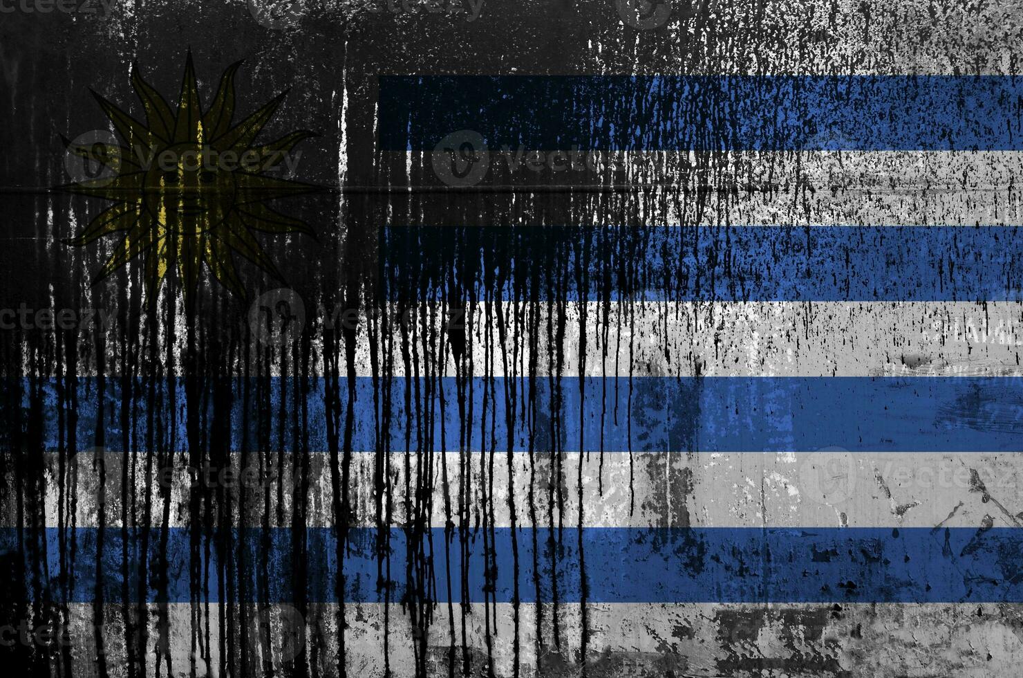 Uruguay flag depicted in paint colors on old and dirty oil barrel wall closeup. Textured banner on rough background photo