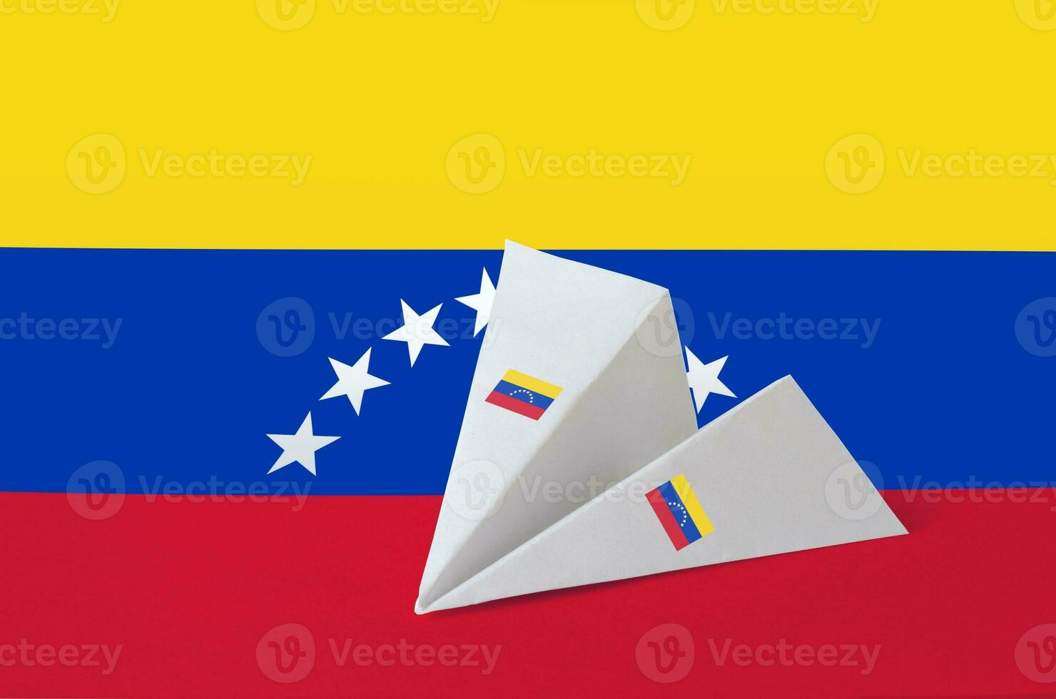 Venezuela flag depicted on paper origami airplane. Handmade arts concept photo