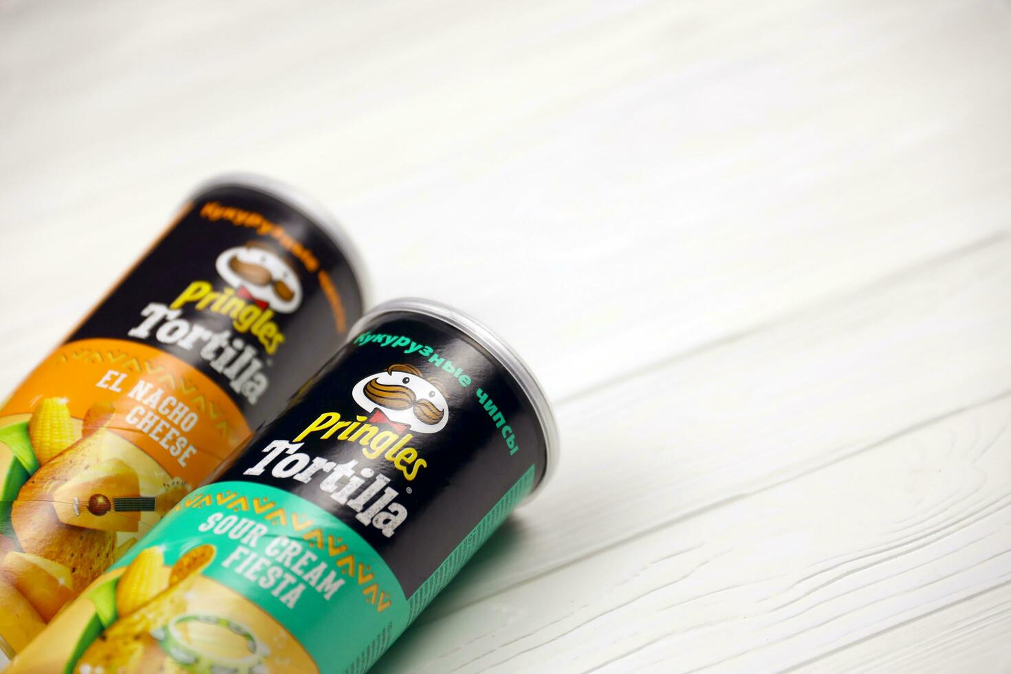 Pringles cylinder tubes with Tortilla el nacho cheese and sour cream fiesta flavour. Pringles is a brand of potato snack chips owned by Kellogg Company photo