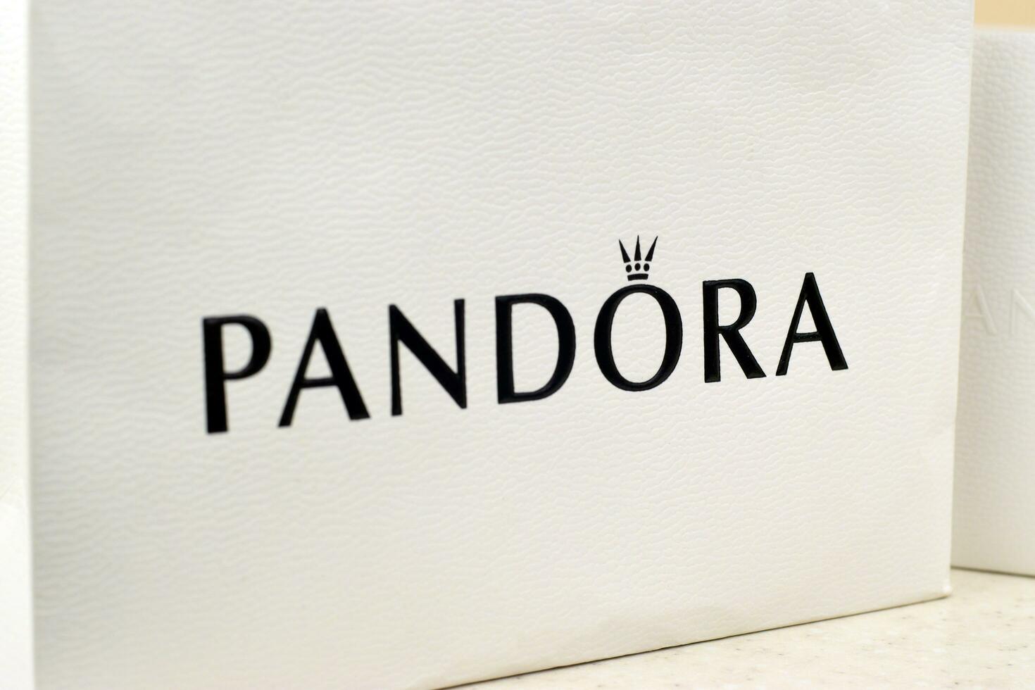 Pandora carrier paper bag with logo. Pandora brand is a manufacturer of jewelry products in Copenhagen, Denmark photo