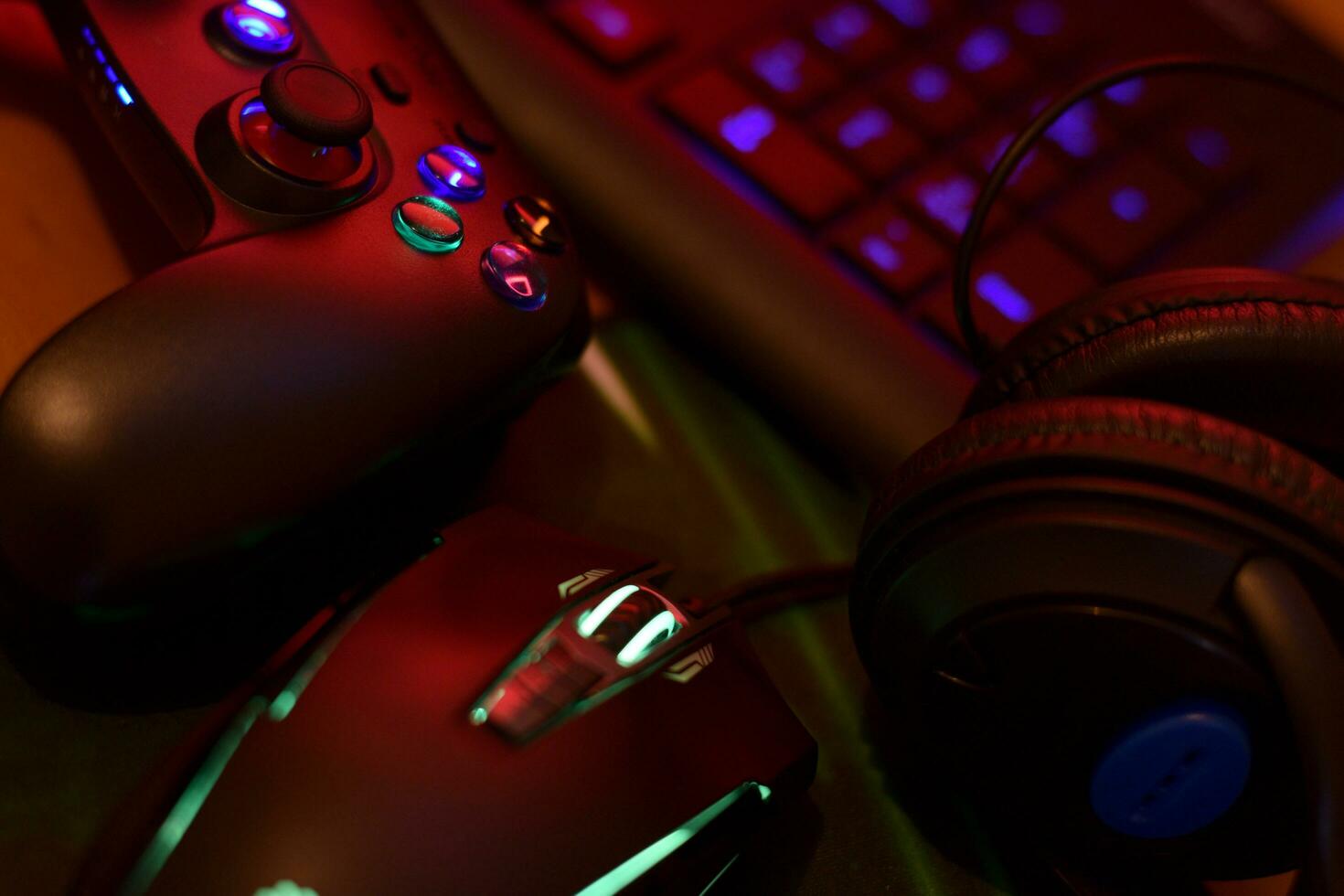 Gamesir g3s video game controller and Bloody p93 gaming mouse on office table with a4tech keyboard and headphones photo