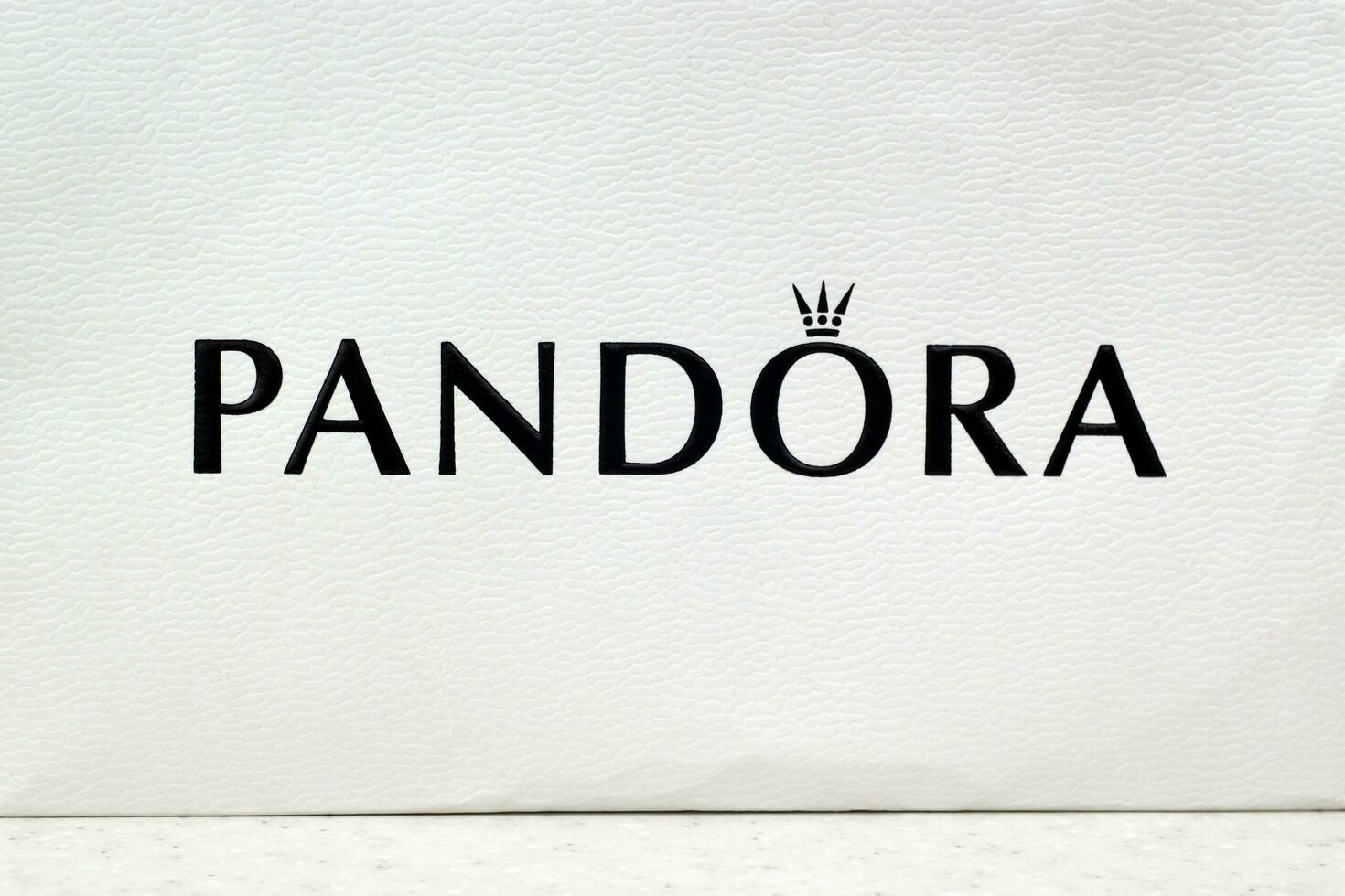 Pandora carrier paper bag with logo. Pandora brand is a manufacturer of jewelry products in Copenhagen, Denmark photo