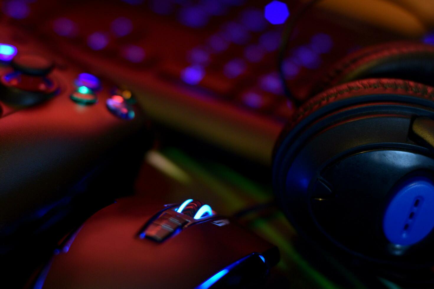 Gamesir g3s video game controller and Bloody p93 gaming mouse on office table with a4tech keyboard and headphones photo
