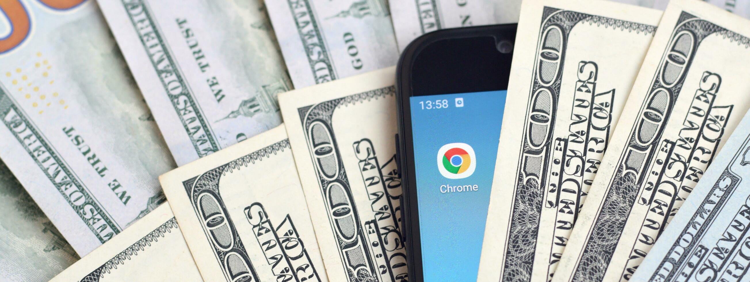 Smartphone screen with Google chrome app and lot of hundred dollar bills. Business and social networking concept photo