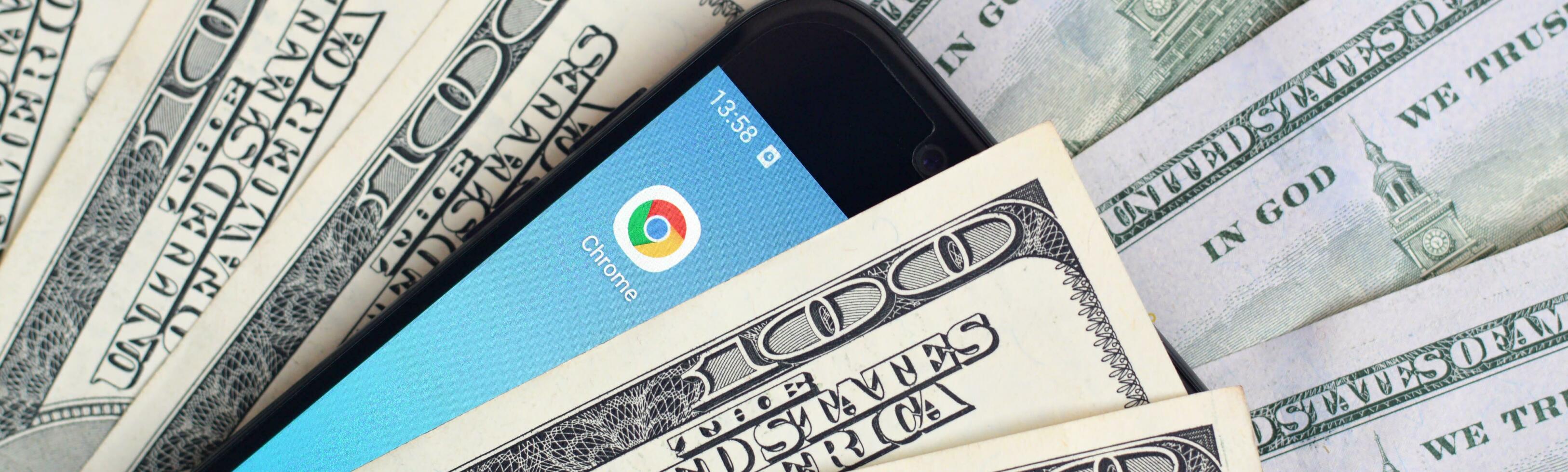 Smartphone screen with Google chrome app and lot of hundred dollar bills. Business and social networking concept photo