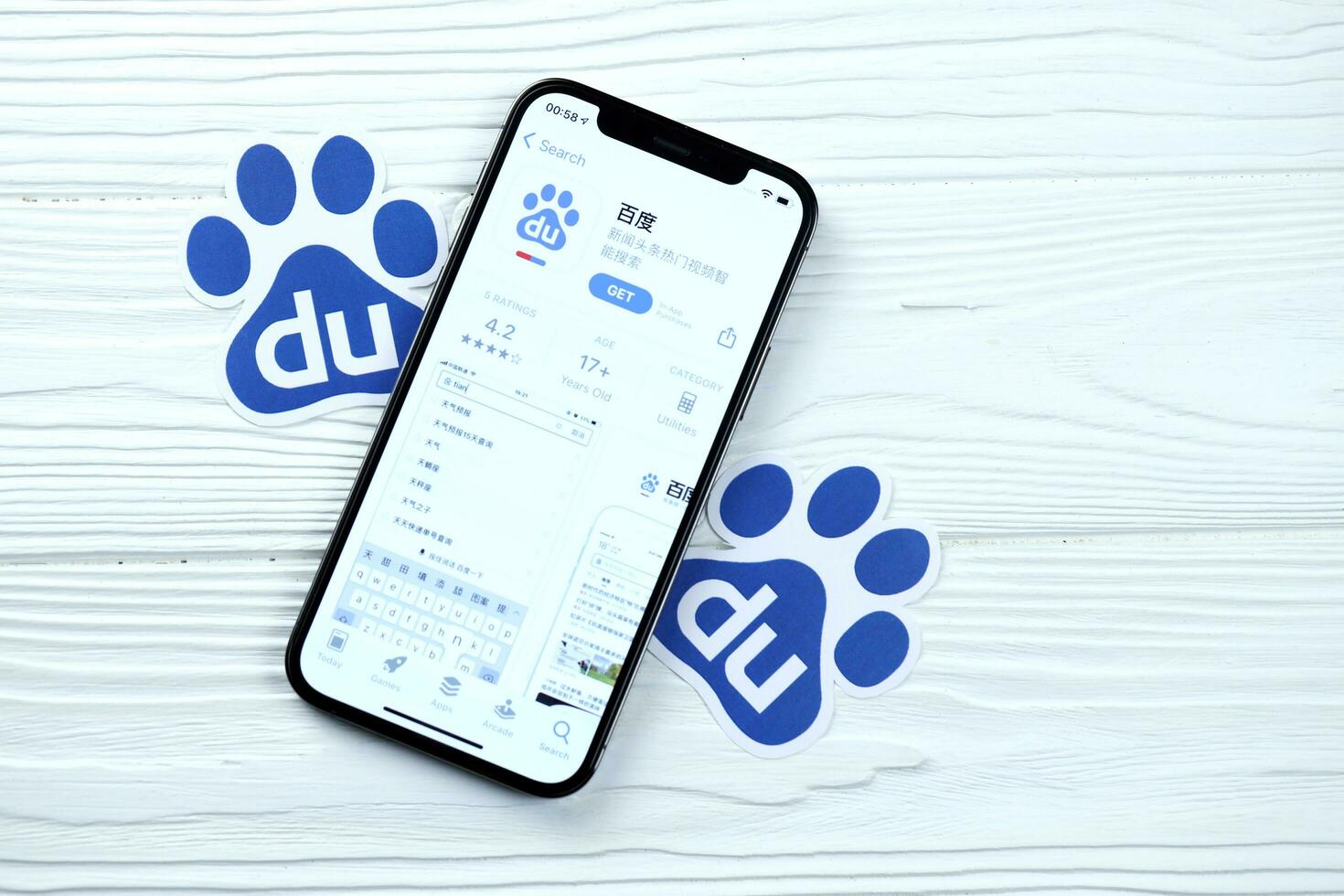 KHARKOV, UKRAINE - MARCH 5, 2021 Baidu icon and application from App store on iPhone 12 pro display screen on white table photo