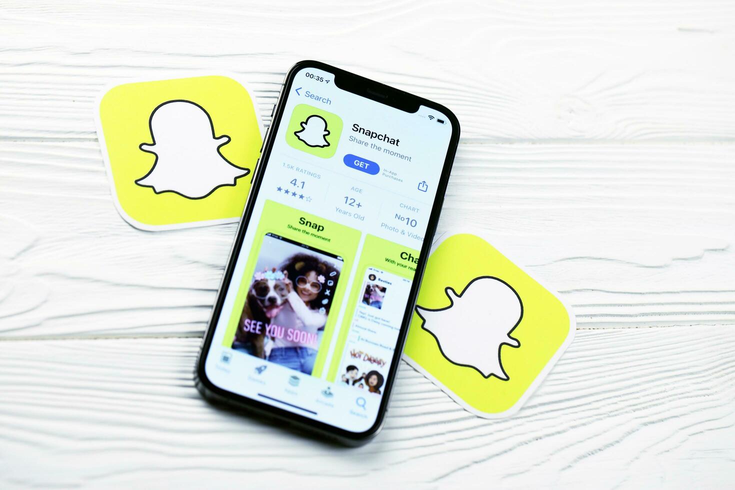 KHARKOV, UKRAINE - MARCH 5, 2021 Snapchat icon and application from App store on iPhone 12 pro display screen on white table photo