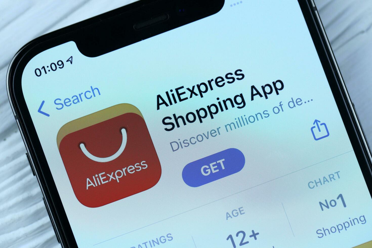 KHARKOV, UKRAINE - MARCH 5, 2021 Aliexpress icon and application from App store on iPhone 12 pro display screen on white table photo